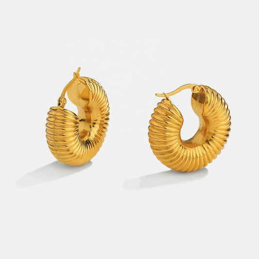 Close-up of 18K gold hoop earrings showing premium finish and design