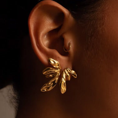 Woman wearing 18K gold geometric wing earrings - bold statement jewelry