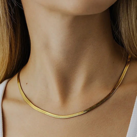 Delicate 18K gold Cuban chain necklace worn on neck - minimalist style"