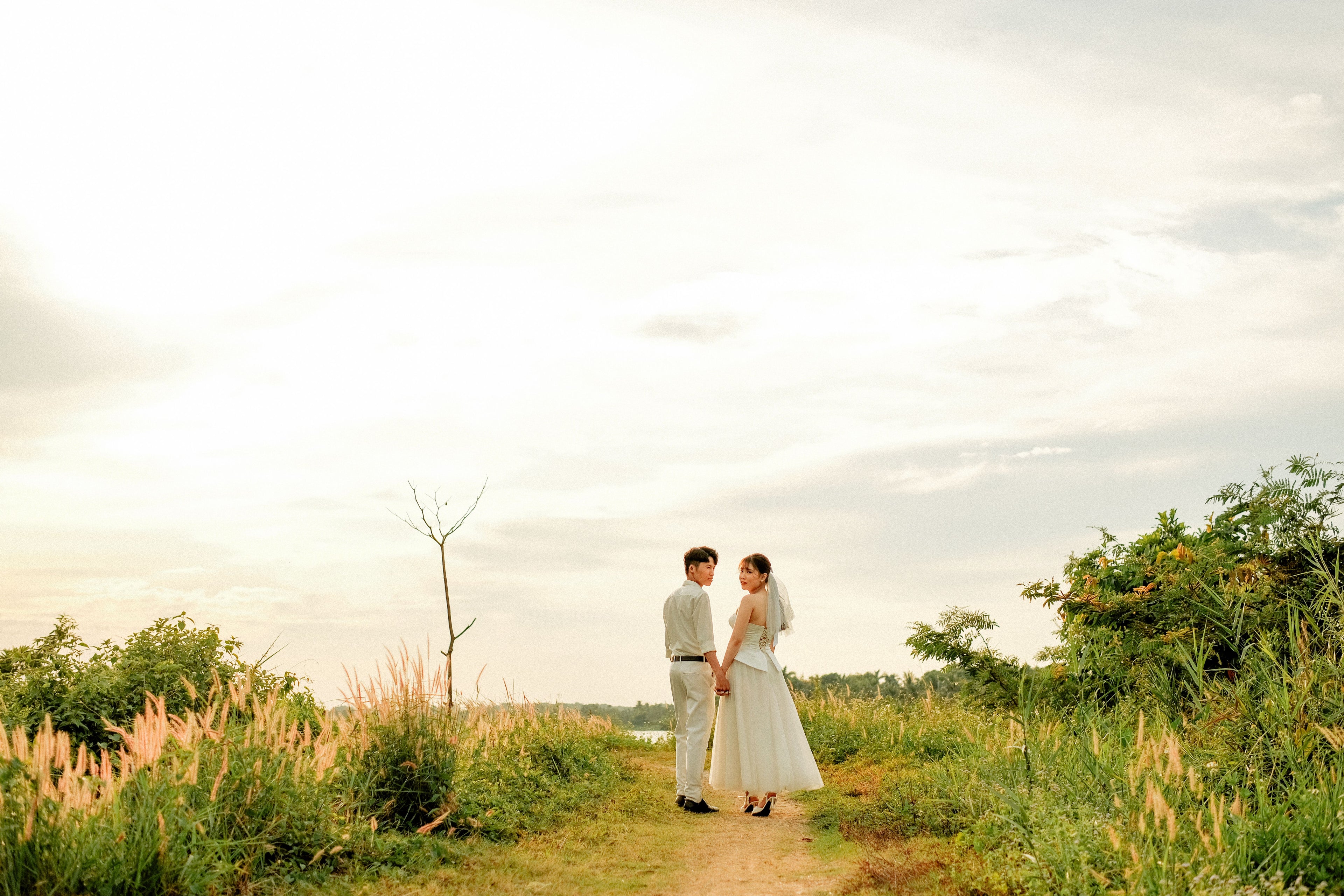 Romantic couple at sunset wedding in a beautiful outdoor setting